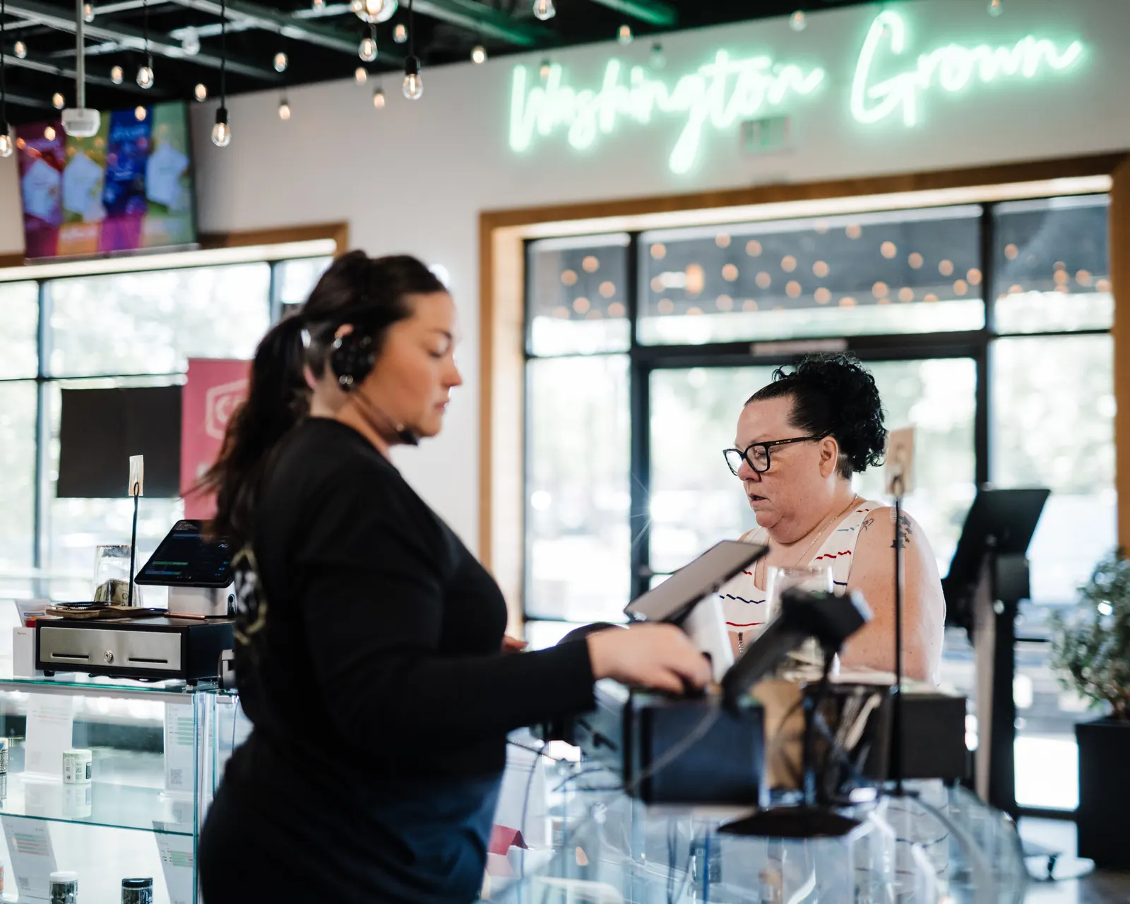 A Craft Cannabis budtender helping a customer at the counter